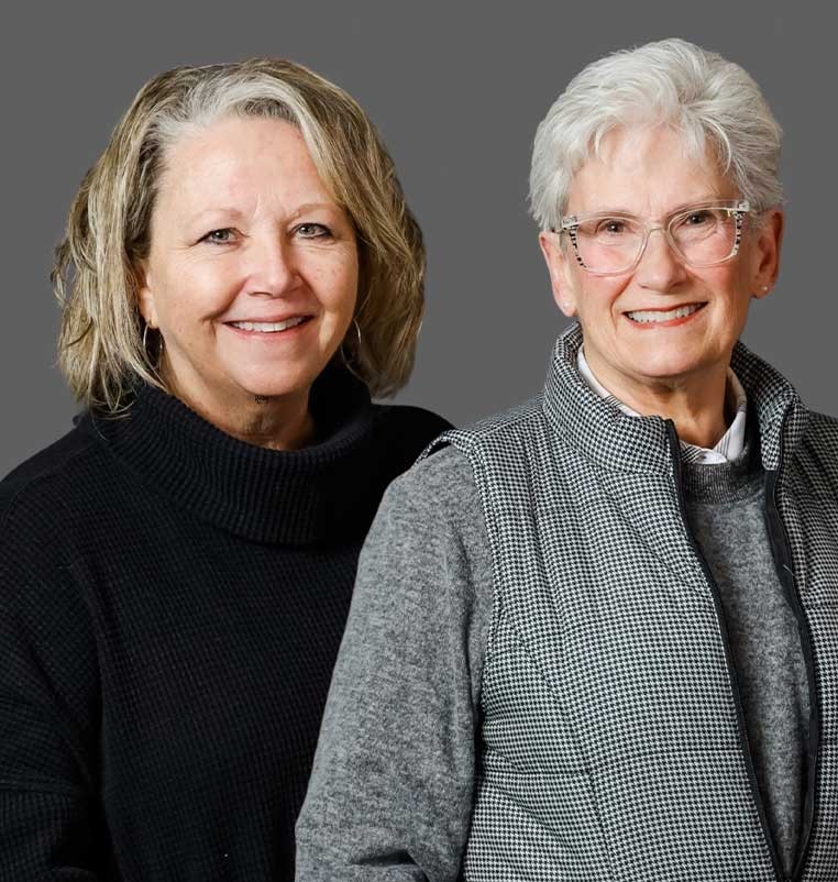 Two smiling women posing for a photo together